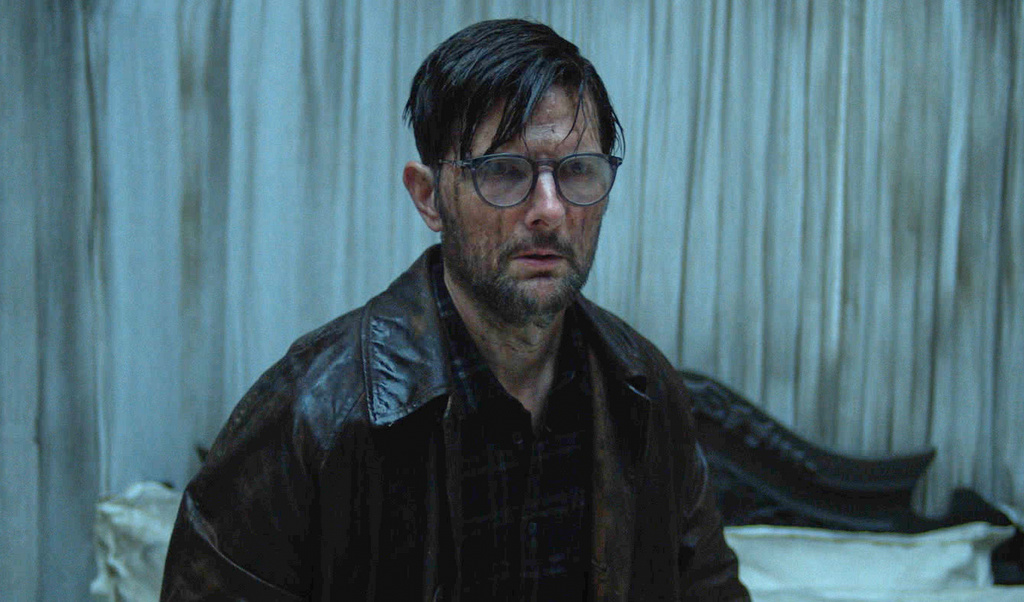 This image released by Neon shows Adam Scott in a scene from "Hokum." (Neon via AP)