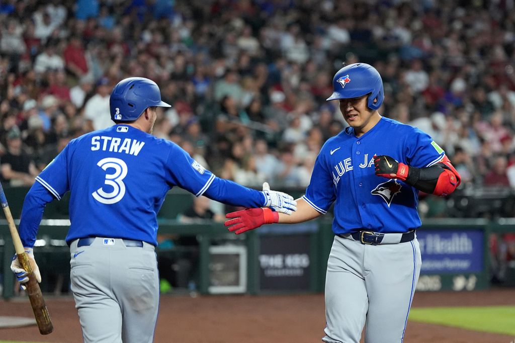 Toronto Blue Jays' Kazuma Okamoto, right, of Japan, celebrates his home run against the Arizona Diamondbacks with Blue Jays' Myles Straw (3) during the third inning of a baseball game, Sunday, April 19, 2026, in Phoenix. (AP Photo/Ross D. Franklin)