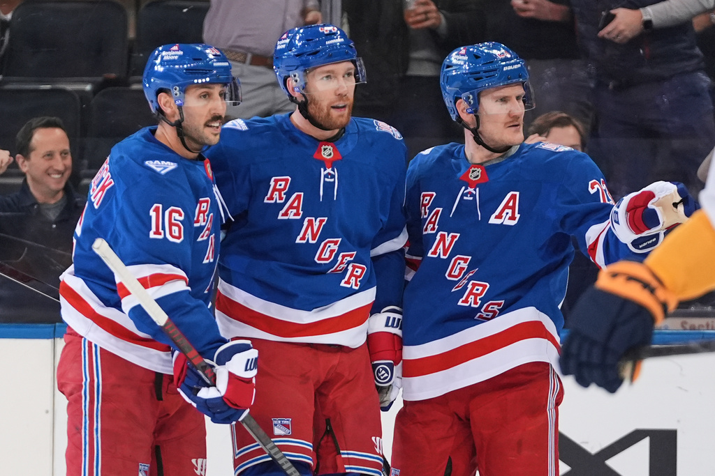 New York Rangers' Vladislav Gavrikov, center, celebrates with Vincent Trocheck, left, and Adam Fox after scorign a goal during the first period of an NHL hockey game against the Nashville Predators Monday, Nov. 10, 2025, in New York. (AP Photo/Frank Franklin II)