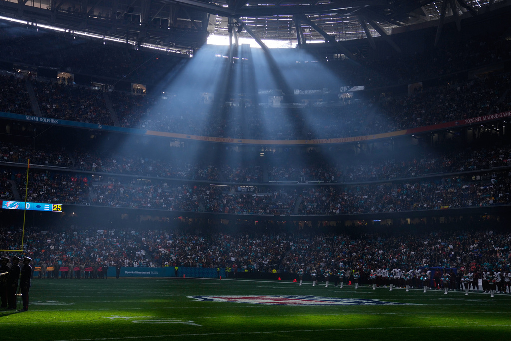 FILE - A shaft of sunlight streams into the stadium before an NFL football game between the Washington Commanders and the Miami Dolphins in Madrid, Spain, Sunday, Nov. 16, 2025. (AP Photo/Manu Fernandez, file)