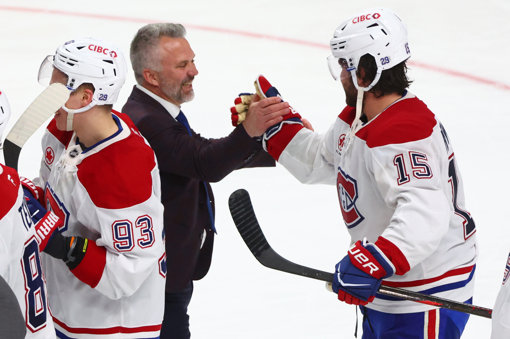 Montreal Canadiens head coach Martin St. Louis shakes hands with Montreal Canadiens center Alex Newhook (15) following the overtime period in Game 7 of a second-round NHL hockey Stanley Cup playoff series against the Buffalo Sabres, Monday, May 18, 2026, in Buffalo, N.Y. (AP Photo/Jeffrey T. Barnes)