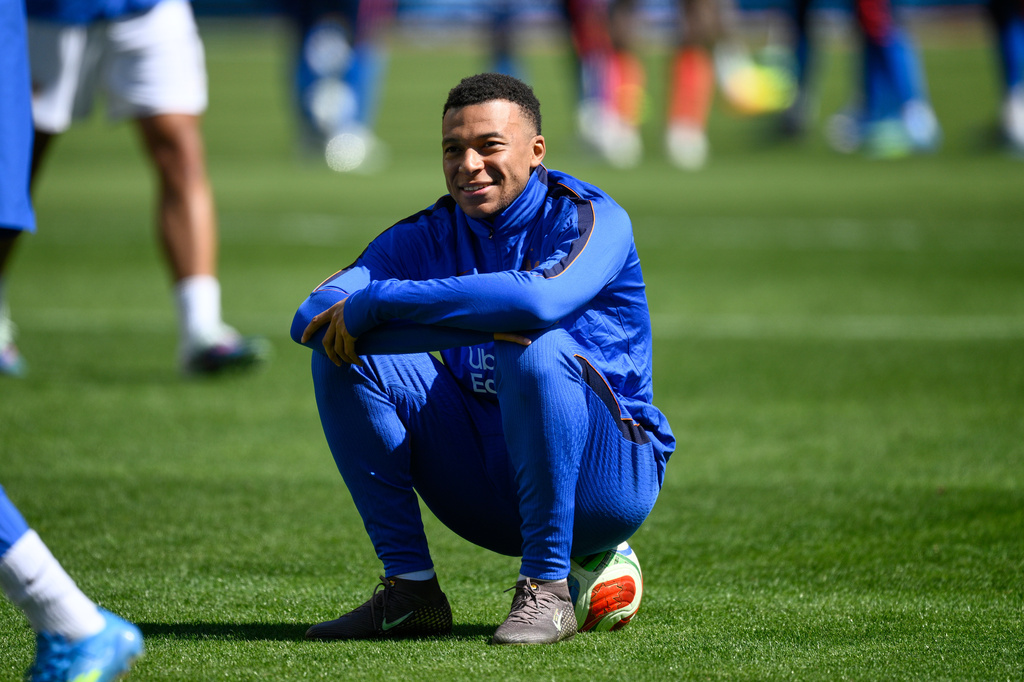 France forward Kylian Mbappé (10) sits on a ball during the warm-up before the international friendly soccer match between Colombia and France in Landover, Md., Sunday, March 29, 2026. (AP Photo/Nick Wass)