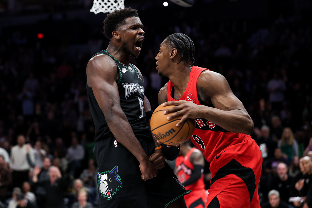 Minnesota Timberwolves guard Anthony Edwards (5) celebrates his dunk in front of Toronto Raptors forward RJ Barrett (9) during the second half of an NBA basketball game Thursday, March 5, 2026, in Minneapolis. (AP Photo/Matt Krohn)