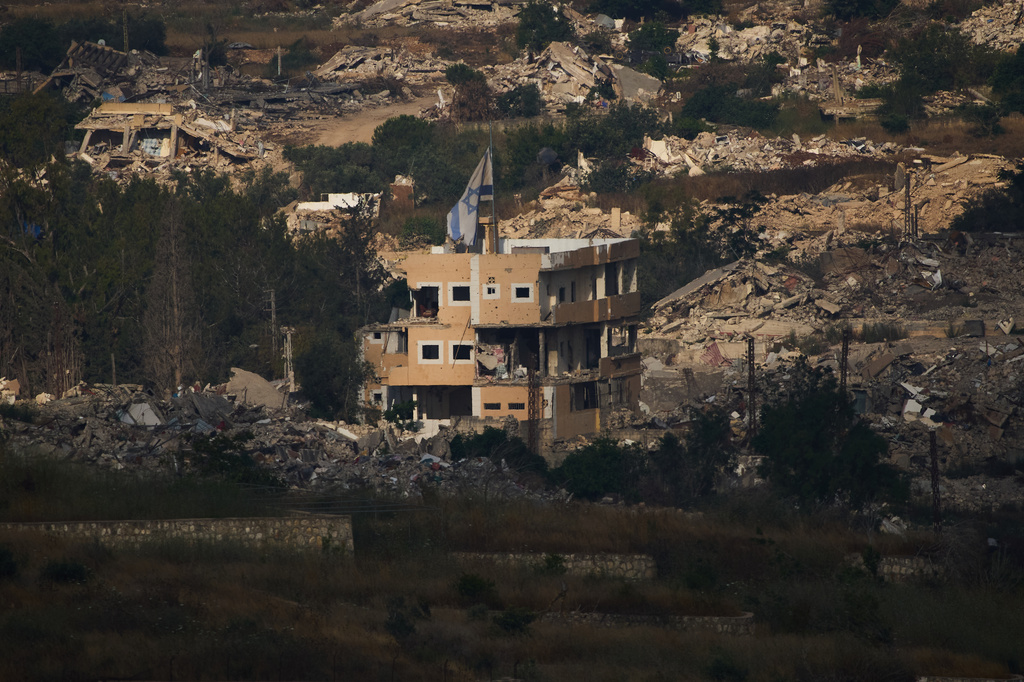 An Israeli flag on a destroyed building in southern Lebanon, as seen from northern Israel, Saturday, June 27, 2026 after Israel and Lebanon sign a framework agreement, described as a first step toward peace following months of conflict between Israel and the Lebanese militant group Hezbollah. (AP Photo/Ariel Schalit)