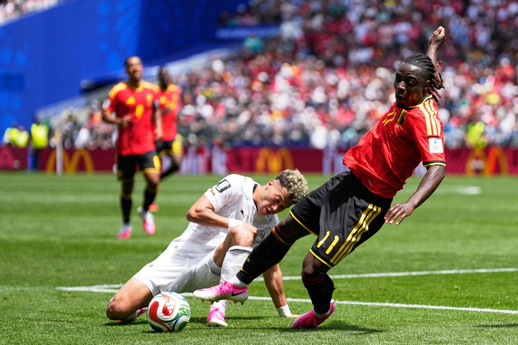 Belgium's Jeremy Doku, front, and Egypt's Emam Ashour fight for the ball during the World Cup Group G soccer match in Seattle, Monday, June 15, 2026. (AP Photo/Lindsey Wasson)