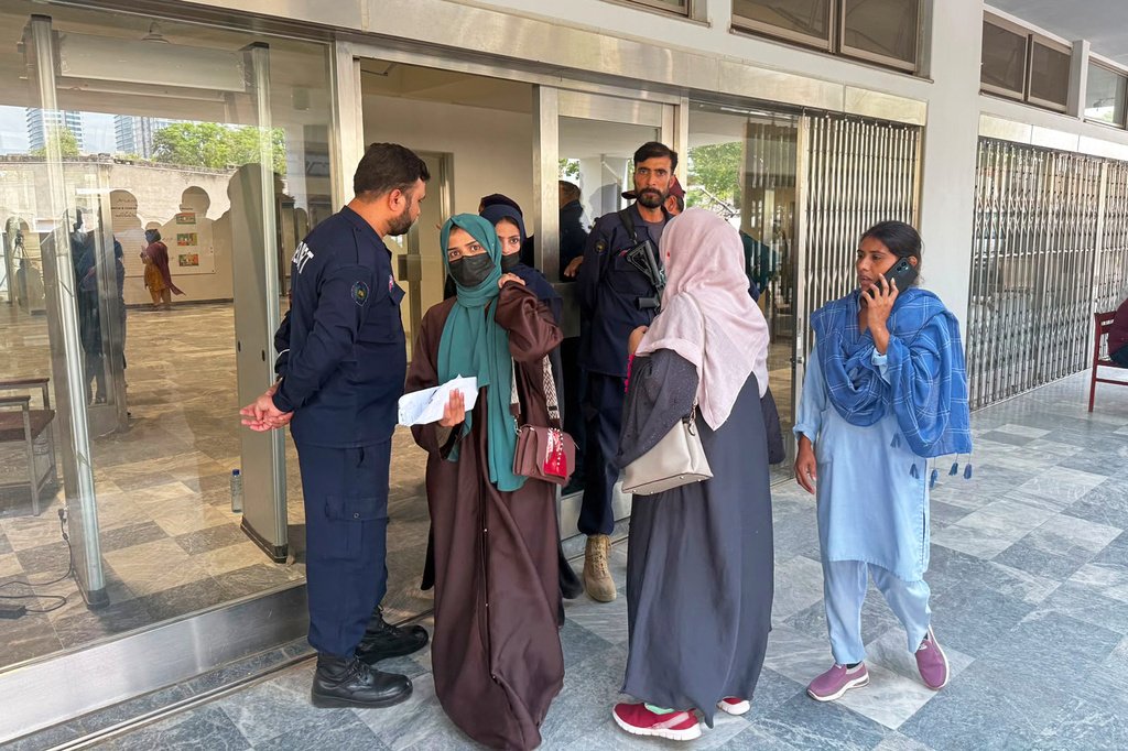 Women leave the Mother and Child Health ward at a hospital, in Islamabad, Pakistan, Thursday, Aug. 27, 2026. (AP Photo/M. Yousaf)