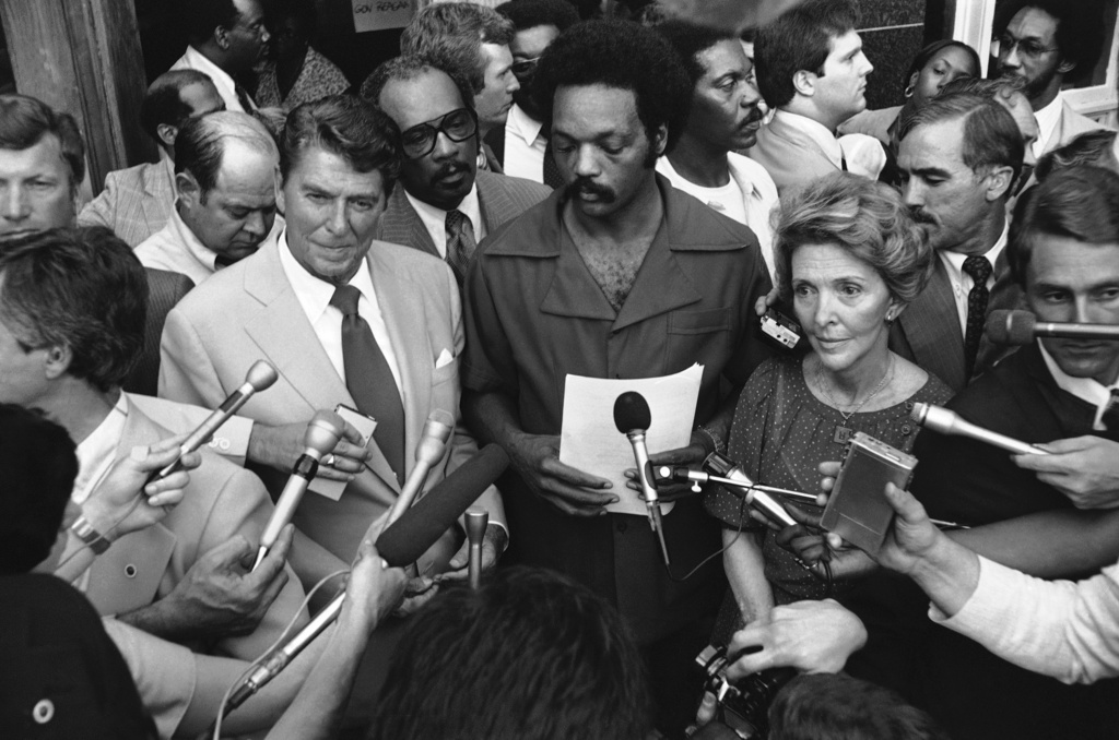 FILE - Republican presidential nominee Gov. Ronald Reagan talks with the Rev. Jesse L. Jackson, director of Operation Push, outside the organization's headquarters in Chicago, Aug. 5,1980. Nancy Reagan is at right. Reagan met with Jackson for an hour then departed for Los Angeles.(AP Photo/Fred Jewell, File)