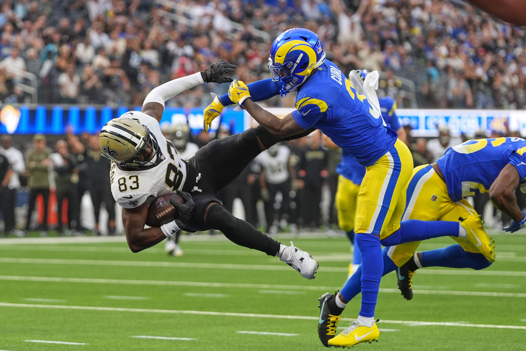 New Orleans Saints tight end Juwan Johnson (83) pulls in a touchdown pass against Los Angeles Rams safety Kam Curl (3) and safety Kamren Kinchens in the first half of an NFL football game Sunday, Nov. 2, 2025, in Inglewood, Calif. (AP Photo/Gregory Bull)