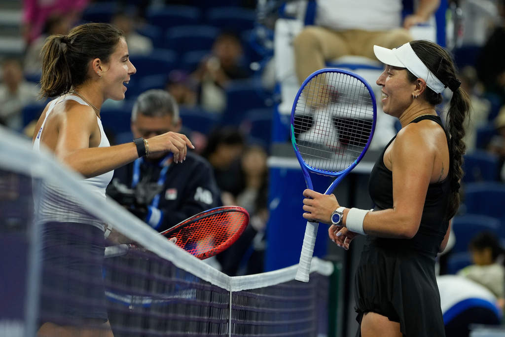 Jessica Pegula of the United States, right is congratulated by compatriot Emma Navarro after their women's singles quarterfinal match of the China Open tennis tournament in Beijing, China, Friday, Oct. 3, 2025. (AP Photo/Ng Han Guan)