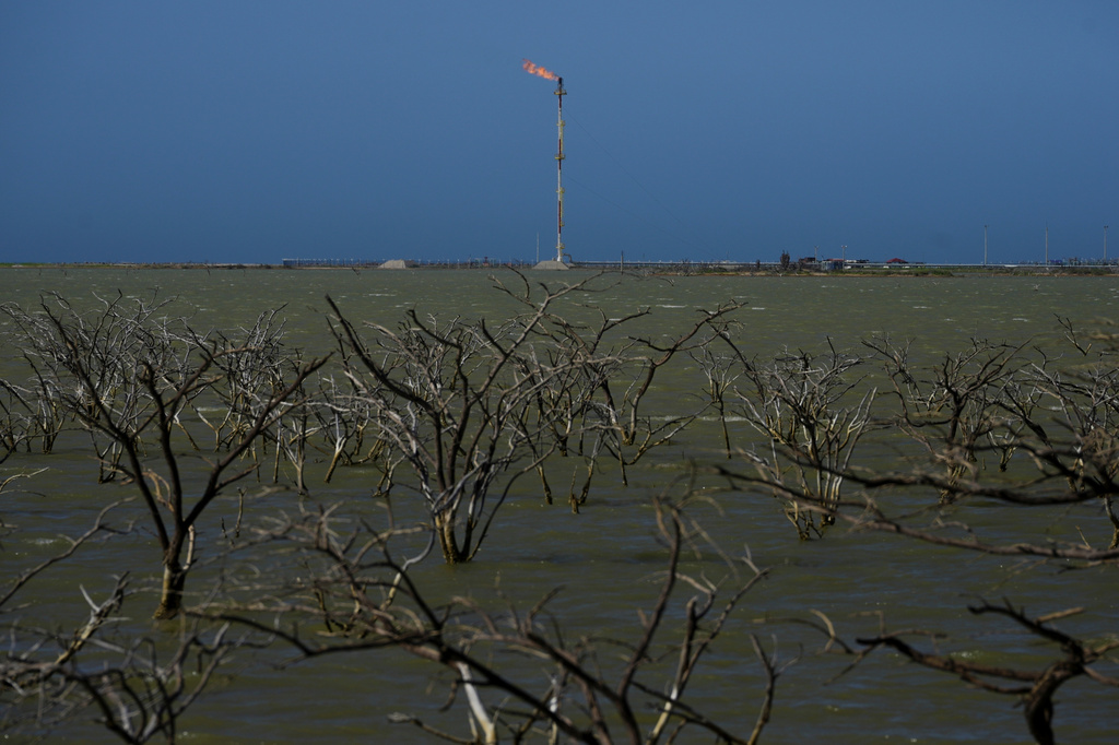 A gas company operates near submerged trees in Manaure, Colombia, Thursday, Feb. 6, 2025. (AP Photo/Ivan Valencia)