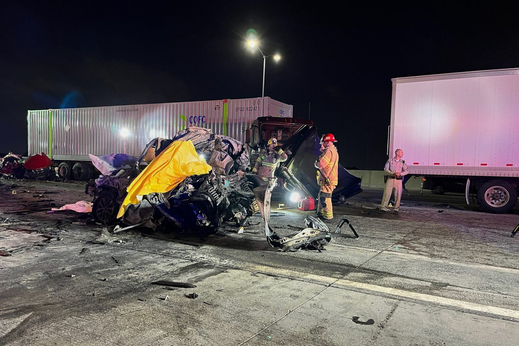 In this photo provided by the San Bernardino County District Attorney’s Office High Tech Crimes Unit, shows officials processing the scene of a deadly multi-vehicle crash Tuesday, Oct. 21, 2025, in Ontario, Calif. (San Bernardino County District Attorney’s Office High Tech Crimes Unit via AP)