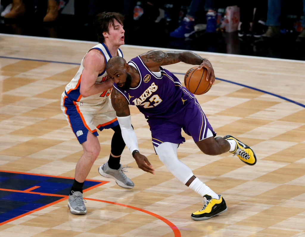 Los Angeles Lakers forward LeBron James (23) dribbles around New York Knicks guard Tyler Kolek, left, during the first half of an NBA basketball game, Sunday, Feb. 1, 2026, in New York. (AP Photo/John Munson)
