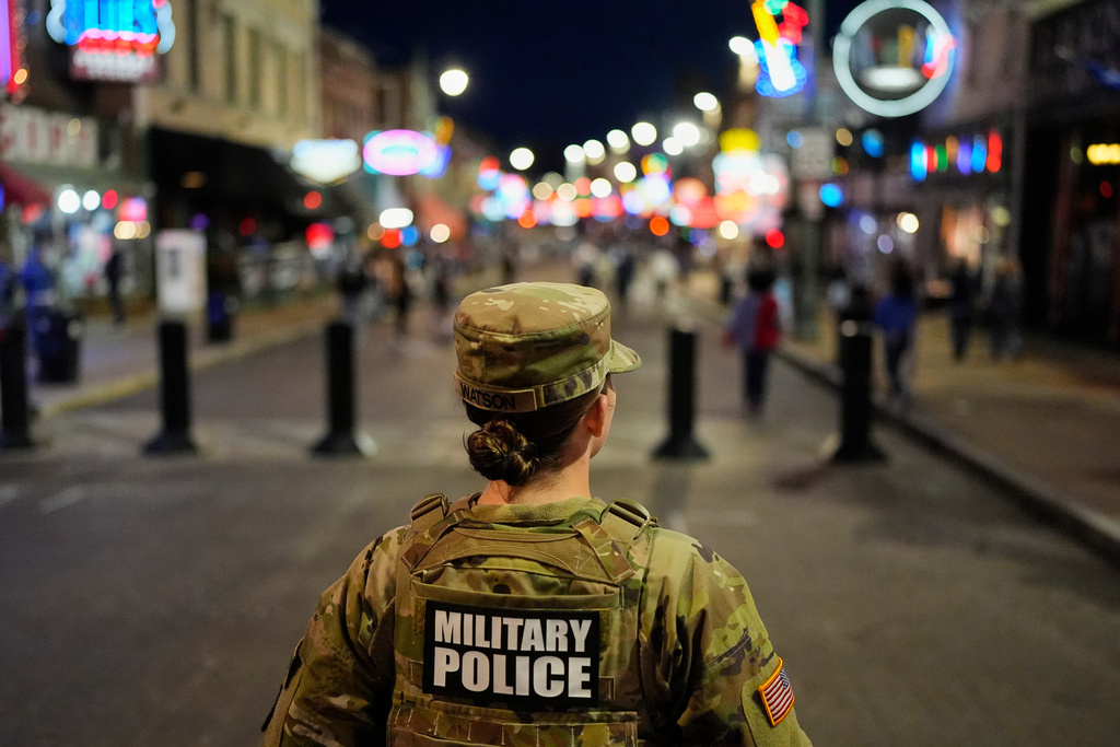 A member of the National Guard stands watch on Beale Street, Friday, Oct. 24, 2025, in Memphis, Tenn. (AP Photo/George Walker IV)