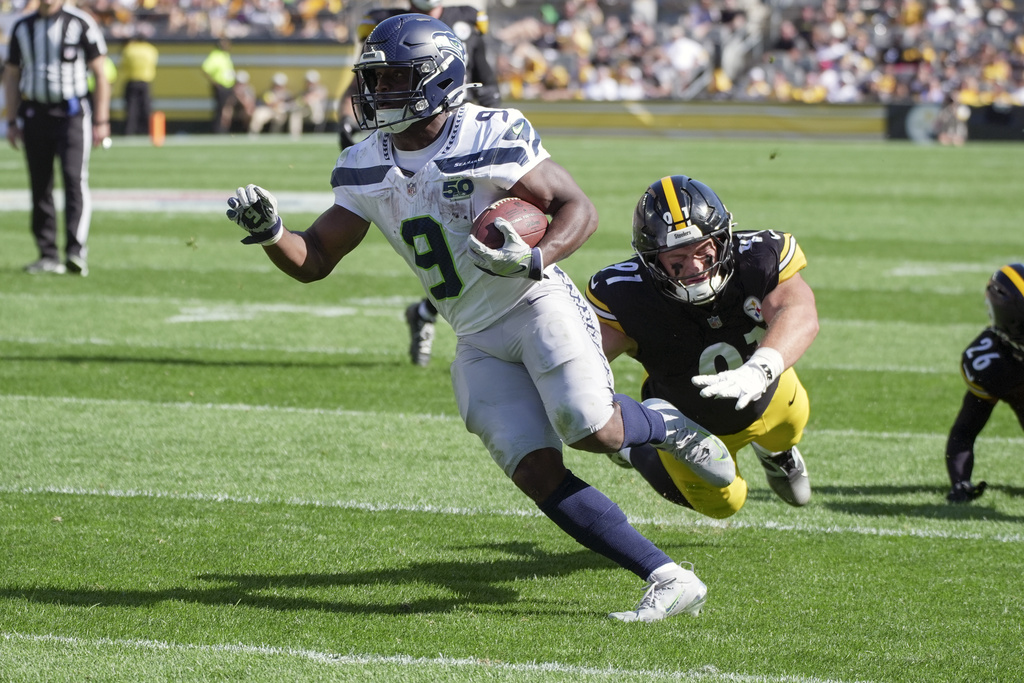 Seattle Seahawks running back Kenneth Walker III (9) gets past Pittsburgh Steelers defensive tackle Logan Lee (91) on a touchdown run during the second half of an NFL football game Sunday, Sept. 14, 2025, in Pittsburgh. (AP Photo/Gene J Puskar)
