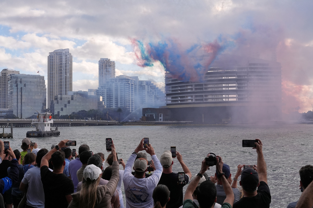People watch pyrotechnics just before the controlled implosion of the former Mandarin Oriental Hotel on Brickell Key, Sunday, April 12, 2026, in Miami. (AP Photo/Rebecca Blackwell)