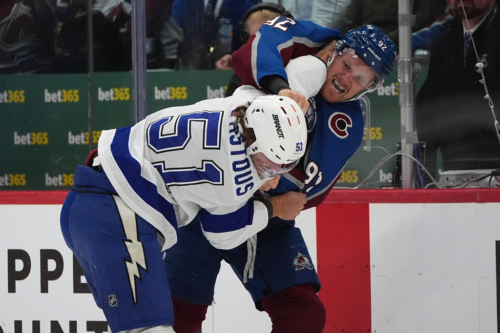 Colorado Avalanche left wing Gabriel Landeskog, back, fights with Tampa Bay Lightning defenseman Charle-Edouard D'Astous in the first period of an NHL hockey game Tuesday, Nov. 4, 2025, in Denver. (AP Photo/David Zalubowski)