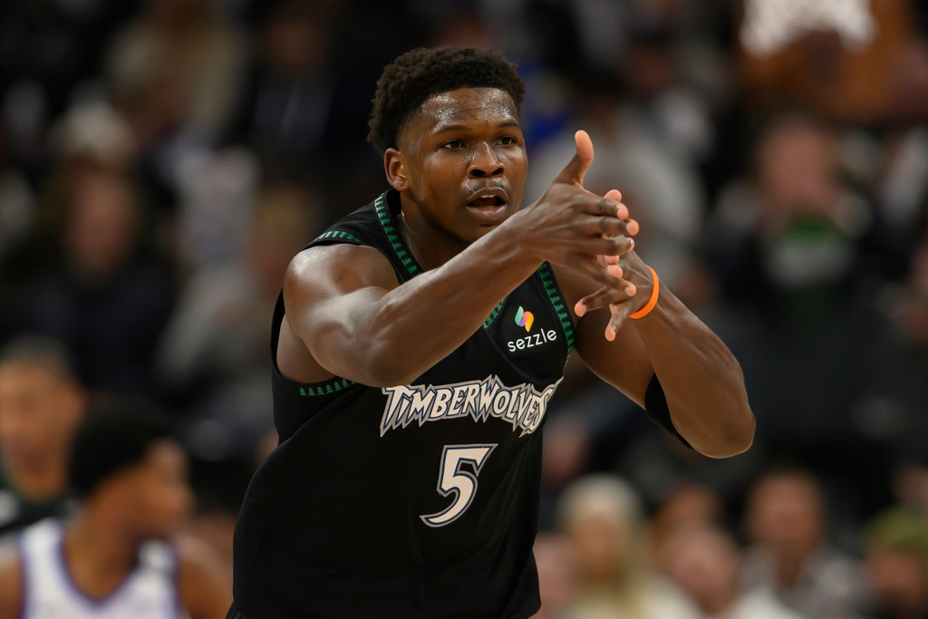 Minnesota Timberwolves guard Anthony Edwards celebrates a three-point play with the bench during the first half of an NBA basketball game against the Utah Jazz, Monday, Nov. 10, 2025, in Salt Lake City. (AP Photo/Tyler Tate)