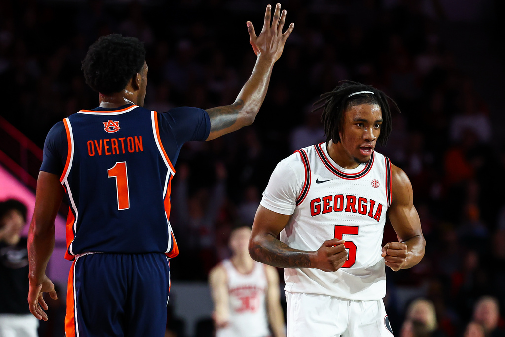 Auburn guard Kevin Overton (1) and Georgia guard Jeremiah Wilkinson (5) react during the first half of an NCAA college basketball game, Saturday, Jan. 3, 2026, in Athens, Ga. (AP Photo/Colin Hubbard)