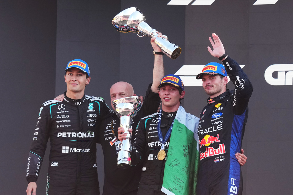 From left Mercedes driver George Russell of Britain, Simone Resta, the Deputy Technical Director for the Mercedes, Mercedes driver Andrea Kimi Antonelli of Italy, and Red Bull driver Max Verstappen of the Netherlands celebrate after the Italian Formula One Grand Prix race, in Monza, Italy, Sunday, Sept. 6, 2026. (AP Photo/Antonio Calanni)