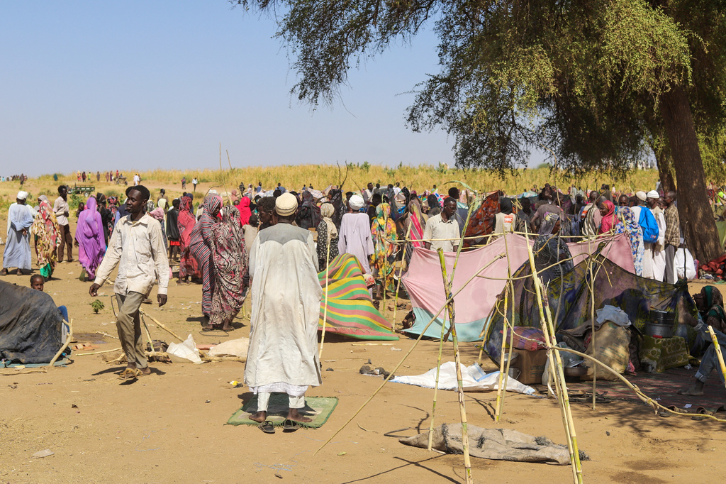 Sudanese who fled el-Fasher city, after Sudan's paramilitary forces killed hundreds of people in the western Darfur region, gather at their camp in Tawila, Sudan, Wednesday, Oct. 29, 2025. (AP Photo/Muhnnad Adam)