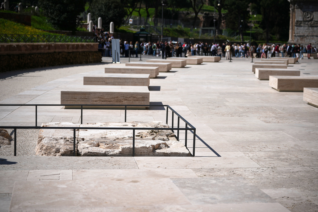 People walk in the new outdoor space created with travertine marble around the Colosseum during it's inauguration in Rome, Tuesday, March 17, 2026. (AP Photo/Andrew Medichini)