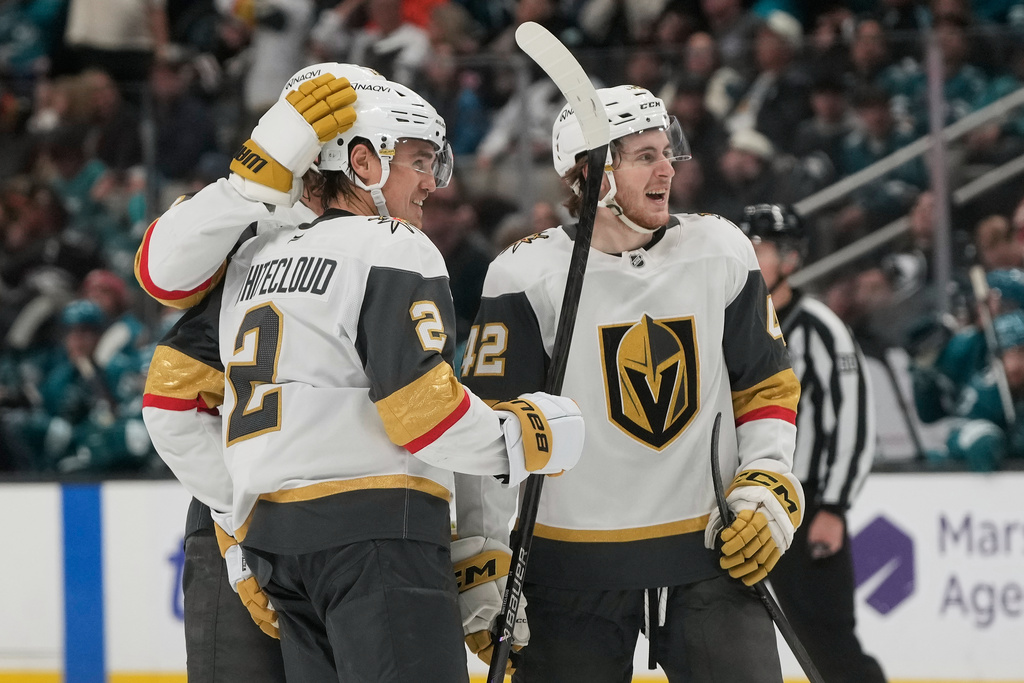 Vegas Golden Knights defenseman Zach Whitecloud (2) is congratulated by defenseman Noah Hanifin, left, and right wing Braeden Bowman (42) after scoring against the San Jose Sharks during the second period of an NHL hockey game in San Jose, Calif., Sunday, Jan. 11, 2026. (AP Photo/Jeff Chiu)