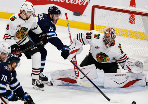 Chicago Blackhawks' Sam Rinzel (6) defends against Winnipeg Jets' Jonathan Toews (19) during second-period NHL hockey game action in Winnipeg, Manitoba, Thursday, Oct. 30, 2025. (John Woods/The Canadian Press via AP) Chicago Blackhawks' Sam Rinzel (6) defends against Winnipeg Jets' Jonathan Toews (19) during second-period NHL hockey game action in Winnipeg, Manitoba, Thursday, Oct. 30, 2025. (John Woods/The Canadian Press via AP)