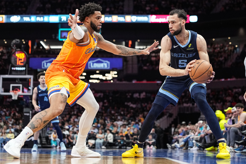 Charlotte Hornets forward Miles Bridges defends Memphis Grizzlies forward Tyler Burton (5) during the second half of an NBA basketball game Saturday, March 21, 2026, in Charlotte, N.C. (AP Photo/Matt Kelley)