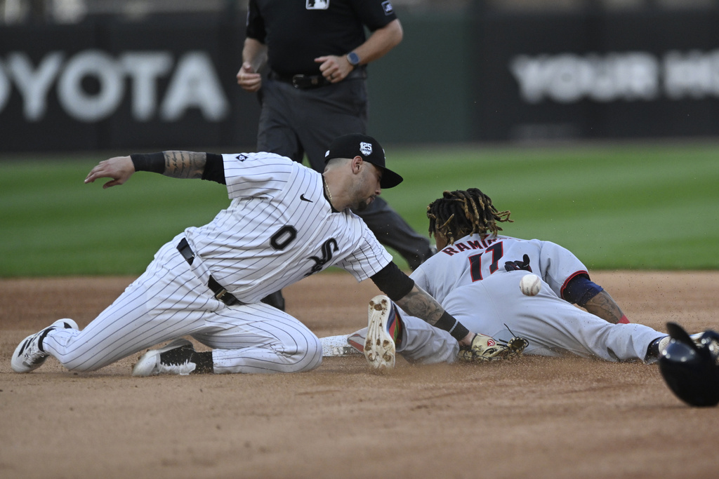 Chicago White Sox shortstop Jacob Amaya (0) attempts to tag Cleveland Guardians' Jose Ramirez, right, who slides safely into second base during the third inning of a baseball game Saturday, Aug. 9, 2025, in Chicago. (AP Photo/Paul Beaty)