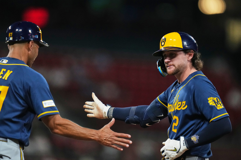 Milwaukee Brewers' Brice Turang (2) is congratulated by first base coach Spencer Allen after hitting a two-run single during the seventh inning of a baseball game against the St. Louis Cardinals Monday, July 6, 2026, in St. Louis. (AP Photo/Jeff Roberson)