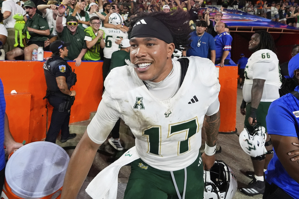 South Florida quarterback Byrum Brown celebrates after defeating Florida in an NCAA college football game, Saturday, Sept. 6, 2025, in Gainesville, Fla. (AP Photo/John Raoux)