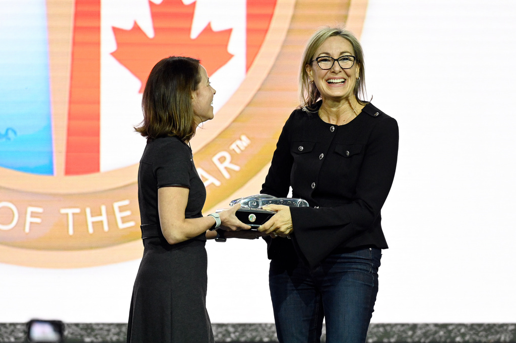 North American Car and Truck of the Year Board Secretary Jill Ciminillo, left, presented the North American Truck of the Year award to Ford Motor Company Vehicle Programs Director Pamela Wylie for the Ford Maverick Lobo, Wednesday, Jan. 14, 2026, in Detroit. (AP Photo/Jose Juarez)