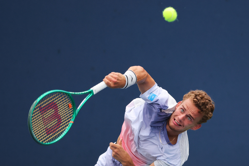 Luca van Assche, of France, returns the ball to Cameron Norrie, of Britain, during the first round of the U.S. Open tennis championships, Sunday, Aug. 30, 2026, in New York. (AP Photo/Andres Kudacki)