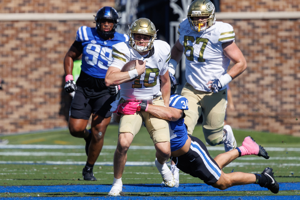 Georgia Tech's Haynes King (10) is tackled by Duke's Luke Mergott (34) during the first half of an NCAA college football game in Durham, N.C., Saturday, Oct. 18, 2025. (AP Photo/Ben McKeown)