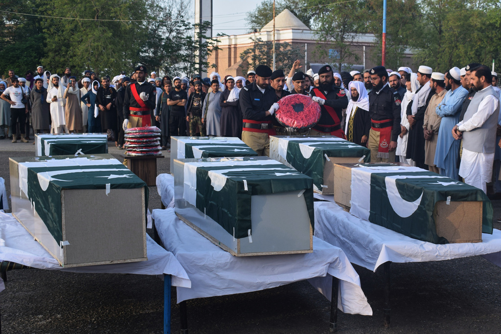 People attend the funeral prayers of police officers, killed in the roadside bomb explosion, outskirts of Lakki Marwat, a district in northwest Pakistan, Friday, March 13, 2026. (AP Photo/G.A. Marwat)