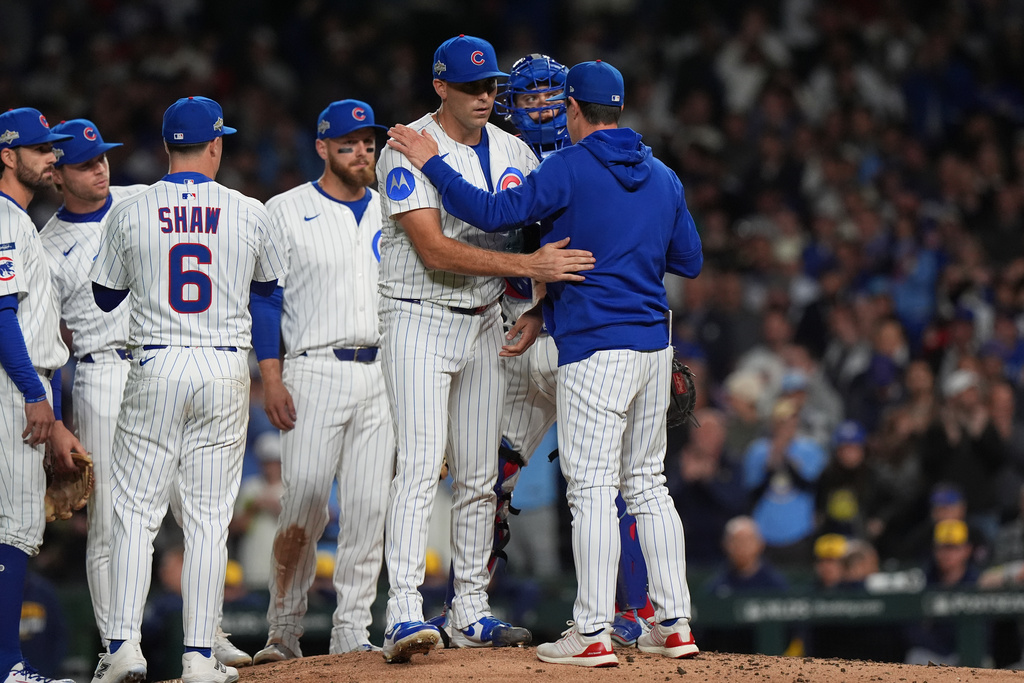 Chicago Cubs manager Craig Counsell acknowledges starting pitcher Matthew Boyd (16) while making a pitching change during the fifth inning of Game 4 of baseball's National League Division Series against the Milwaukee Brewers Thursday, Oct. 9, 2025, in Chicago. (AP Photo/Nam Y. Huh)
