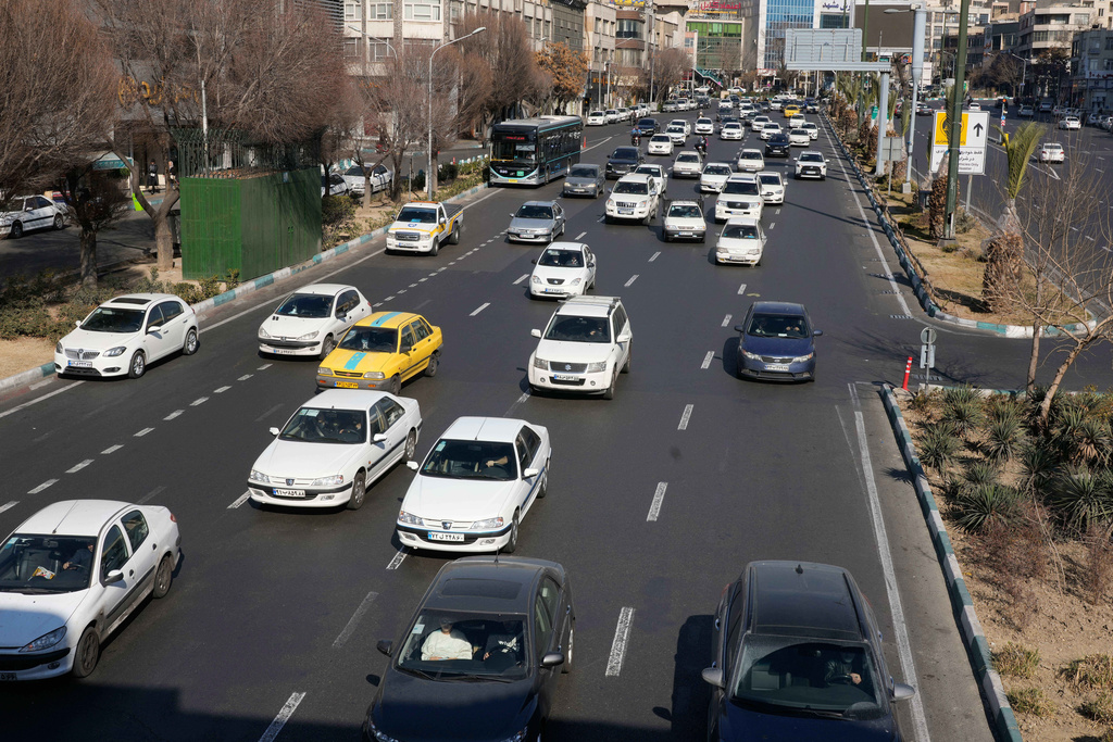 Vehicles drive in downtown Tehran, Iran, Friday, Jan. 16, 2026. (AP Photo/Vahid Salemi)