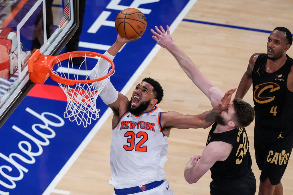 New York Knicks center Karl-Anthony Towns (32) shoots against Cleveland Cavaliers forward Dean Wade (32) during the second half of Game 1 in the Eastern Conference finals NBA basketball playoffs series Tuesday, May 19, 2026, in New York. (AP Photo/Yuki Iwamura)