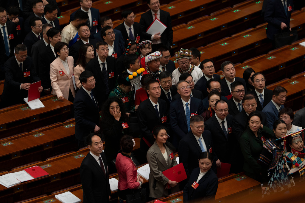 Delegates leave after the closing session of the National People's Congress (NPC) at the Great Hall of the People in Beijing, Thursday, March 12, 2026. (AP Photo/Ng Han Guan)
