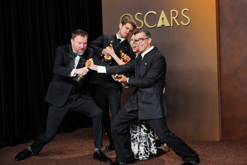 Jack Piatt, far left, and Sam A. Davis, center left, winners of the award for live action short film for "The Singers," and Natalie Musteata, center right, and Alexandre Singh, far right, winners of the award for live action short film for "Two People Exchanging Saliva," pose in the press room after tying in the category for live action short film at the Oscars on Sunday, March 15, 2026, at the Dolby Theatre in Los Angeles. (Photo by Jordan Strauss/Invision/AP)