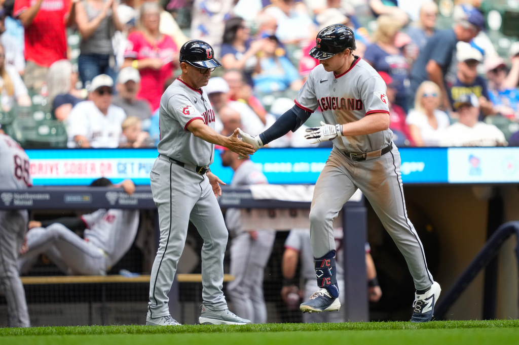 Cleveland Guardians' Kyle Manzardo, right, high-fives third base and infield coach Rouglas Odor, left, after hitting a home run during the sixth inning of a baseball game against the Milwaukee Brewers, Thursday, June 18, 2026, in Milwaukee. (AP Photo/Kayla Wolf)
