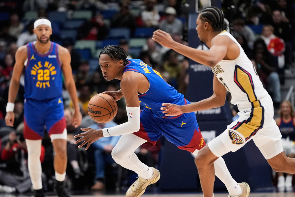 Denver Nuggets guard Peyton Watson drives against New Orleans Pelicans forward Trey Murphy III (25) in the second half of an NBA basketball game, Tuesday, Jan. 13, 2026, in New Orleans. (AP Photo/Gerald Herbert)