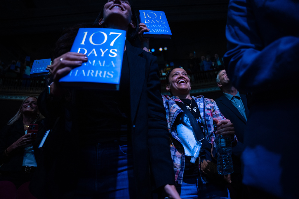 People display their copies of former Vice President Kamala Harris' new book "107 Days," about her presidential campaign on the first stop of the book's tour at Town Hall in New York, Wednesday, Sept. 24, 2025. (AP Photo/Angelina Katsanis)