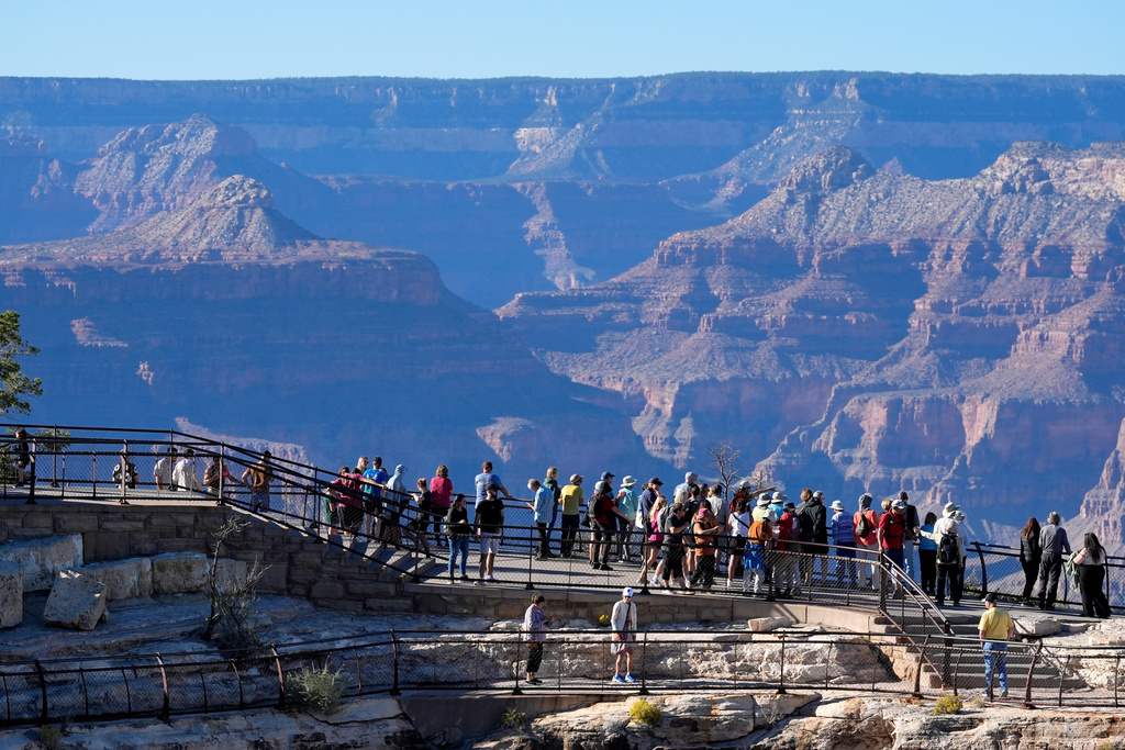 FILE - Tourists flock to Mather Point at Grand Canyon National Park, Oct. 1, 2025, in Grand Canyon, Ariz. (AP Photo/Ross D. Franklin, File)