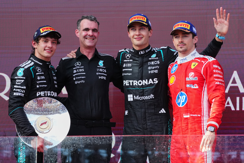 Mercedes driver George Russell of Britain, second right, celebrates with second placed teammate Andrea Kimi Antonelli, left, of Italy and Hywel Thomas, Managing director of Mercedes AMG High Performance Powertrains and third placed Ferrari driver Charles Leclerc, right, of Monaco after winning during the Australian Formula One Grand Prix at Albert Park, in Melbourne, Australia, Sunday, March 8, 2026. (AP Photo/Scott Barbour)