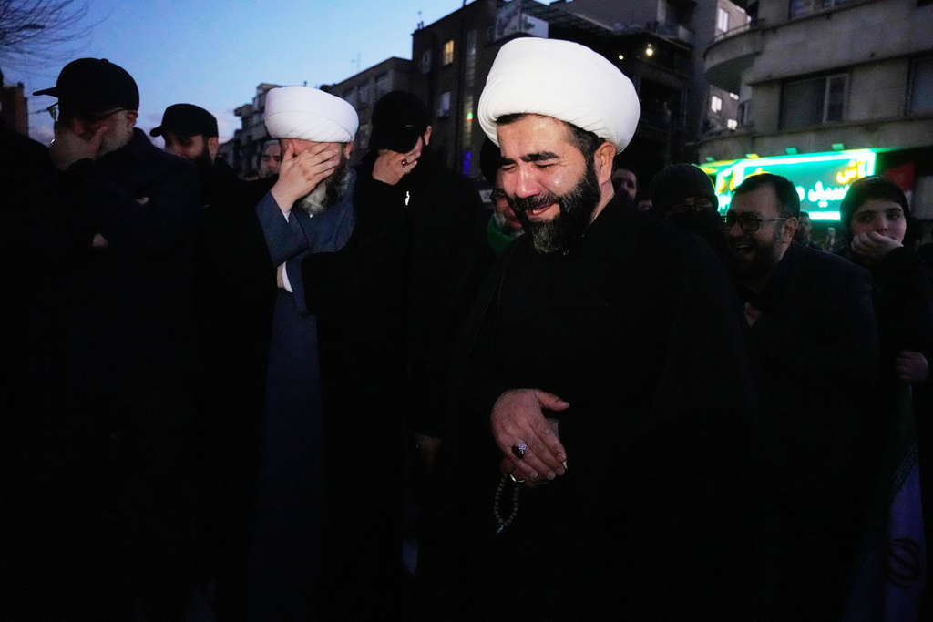 Clerics and other government supporters mourn in a gathering after state TV officially announced the death of Iranian Supreme Leader Ayatollah Ali Khamenei, in Tehran, Iran, Sunday, March 1, 2026. (AP Photo/Vahid Salemi)