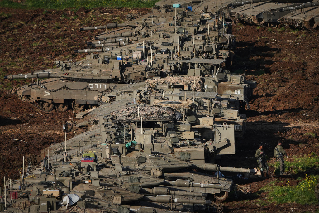 Israeli soldiers work on tanks at a staging area in northern Israel near the border with Lebanon, Friday, March 6, 2026. (AP Photo/Ariel Schalit)