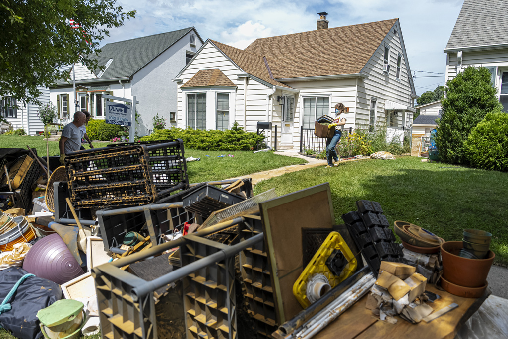 Mandaline Bergstrom works on cleaning out her basement, Aug. 11, 2025, in Milwaukee. (AP Photo/Andy Manis)