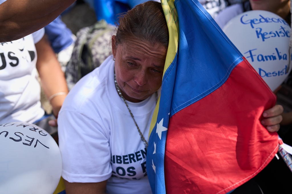 People attend a prayer for freedom of political prisoners, peace and reconciliation, near the Helicoide detention center in Caracas, Venezuela, Saturday, Feb. 7, 2026. (AP Photo/Ariana Cubillos)