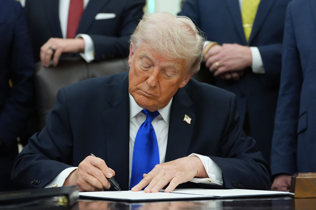 President Donald Trump signs a presidential permit regarding pipeline construction in the Oval Office of the White House, Thursday, April 30, 2026, in Washington. (AP Photo/Alex Brandon)